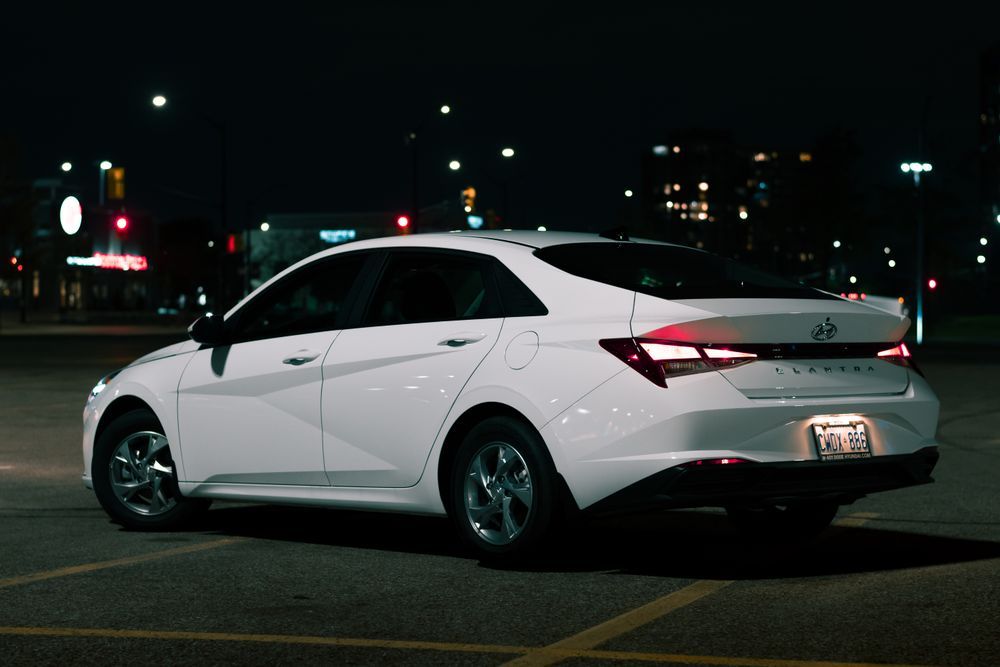 Honda City sedan parked outside a corporate office
