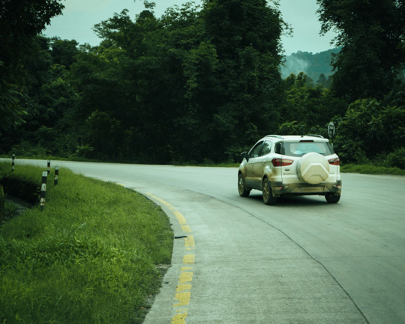 SUV on an open Indian highway at sunrise on a long-distance journey